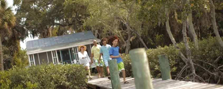 Family strolling along pier at Dollhouse Cottage